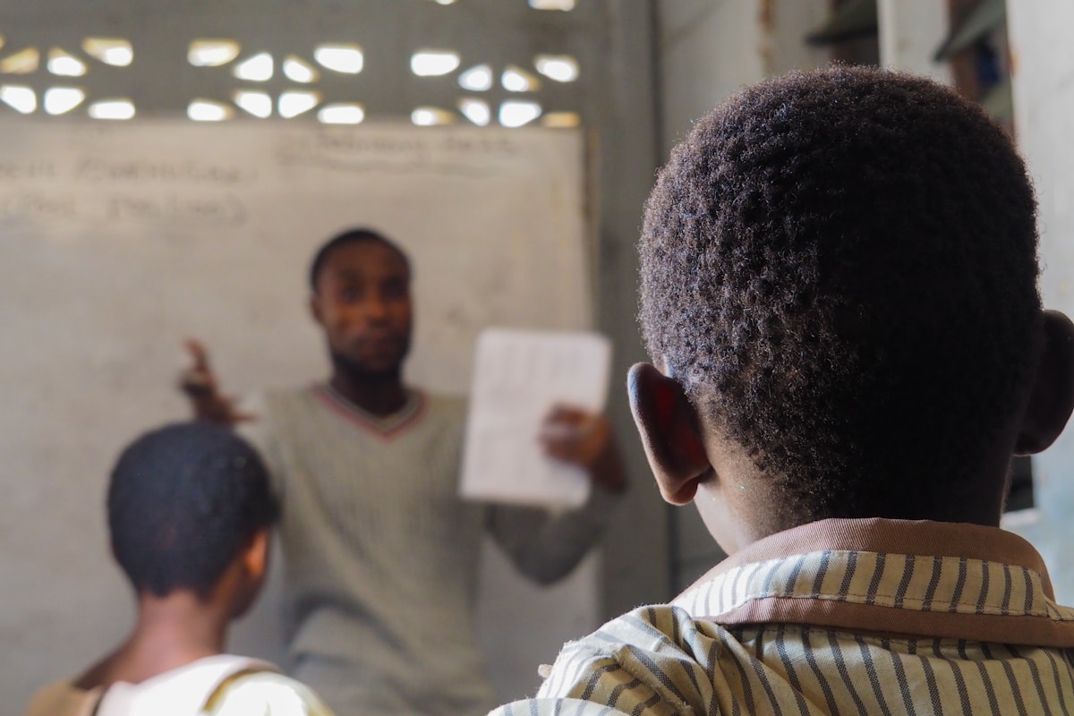 Teacher instructing students in an African classroom